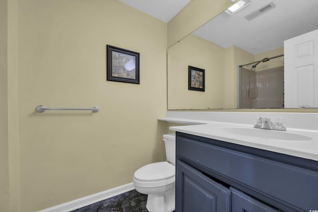 bathroom featuring baseboards, toilet, a shower, and vanity
