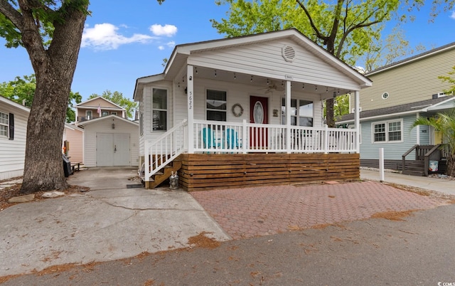 6001 S Kings Hwy, Myrtle Beach, SC 29575 - view of front of home with covered porch, a storage unit, an outbuilding, and a ceiling fan