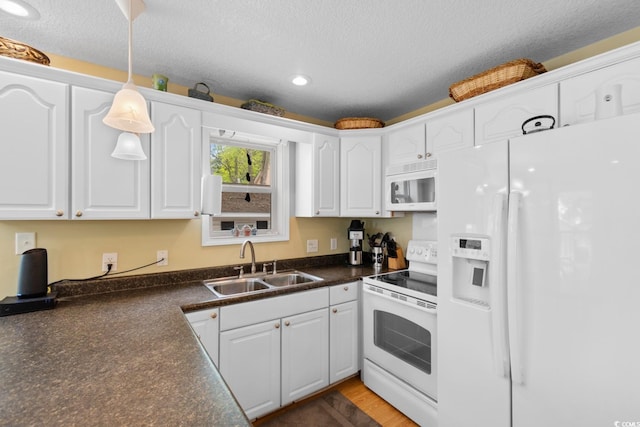 6001 S Kings Hwy, Myrtle Beach, SC 29575 - kitchen featuring white appliances, a sink, dark countertops, white cabinetry, and recessed lighting