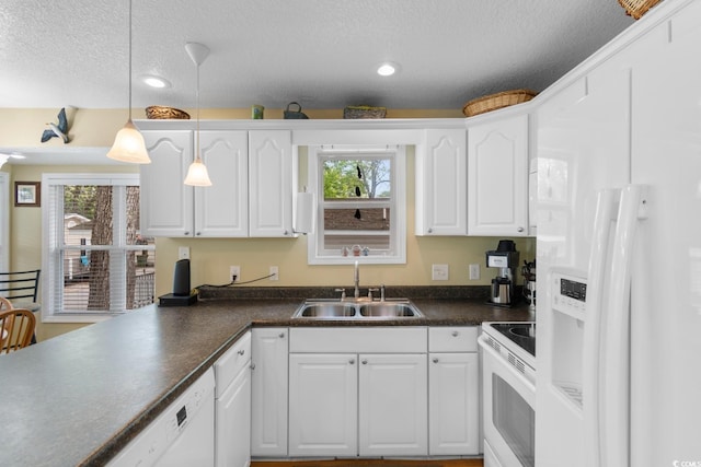 6001 S Kings Hwy, Myrtle Beach, SC 29575 - kitchen with white appliances, a sink, healthy amount of natural light, dark countertops, and a textured ceiling