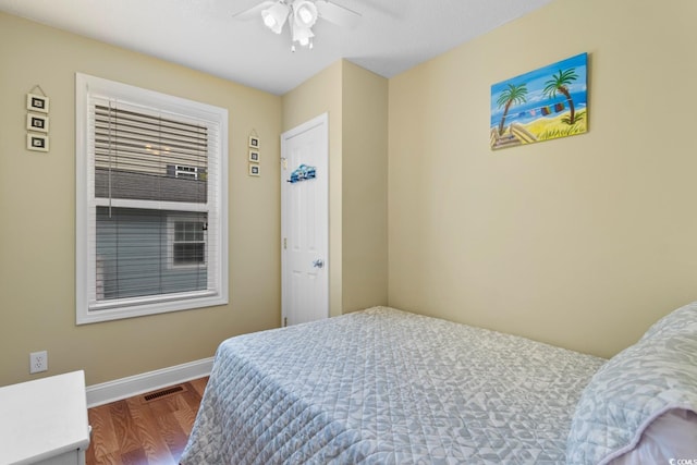 6001 S Kings Hwy, Myrtle Beach, SC 29575 - bedroom featuring baseboards, wood finished floors, and a ceiling fan