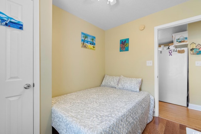 6001 S Kings Hwy, Myrtle Beach, SC 29575 - bedroom with freestanding refrigerator and wood finished floors