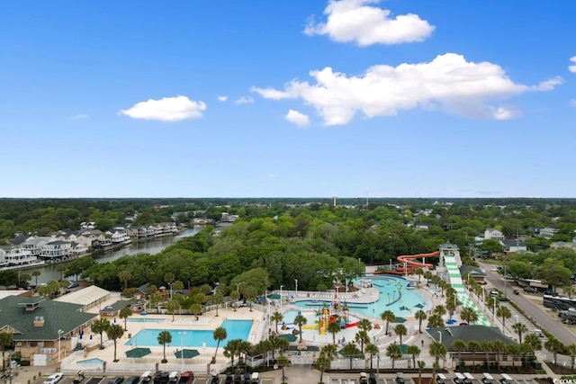 6001 S Kings Hwy, Myrtle Beach, SC 29575 - drone / aerial view of a pool area, a large body of water, and a tree filled landscape