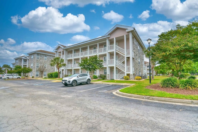 4683 Wild Iris Dr Unit 104, Myrtle Beach, SC 29577 - view of apartment building / complex with uncovered parking