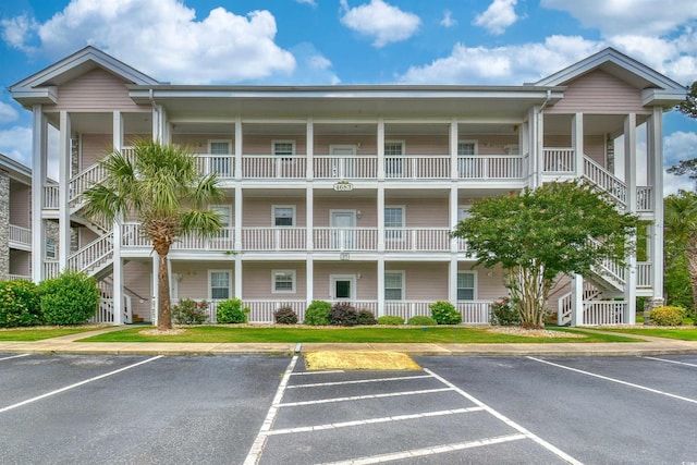 4683 Wild Iris Dr Unit 104, Myrtle Beach, SC 29577 - view of building exterior featuring uncovered parking and stairs