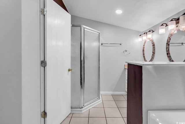 full bath with tile patterned floors, a shower stall, vanity, and baseboards