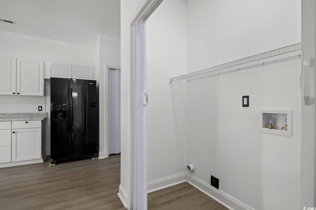 laundry area with dark wood finished floors, washer hookup, and baseboards