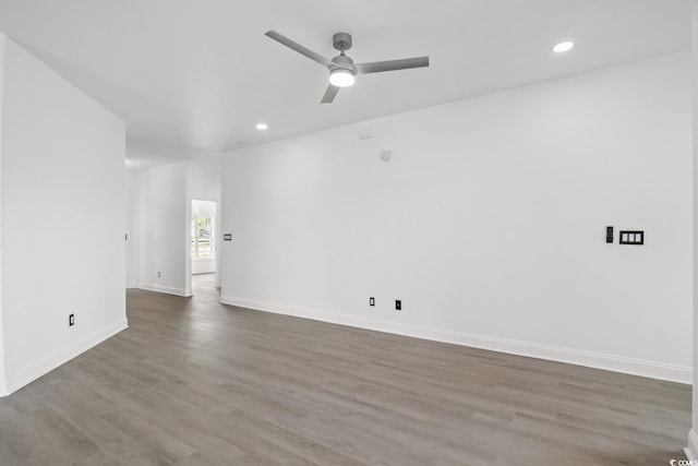 unfurnished room featuring recessed lighting, a ceiling fan, wood finished floors, and baseboards