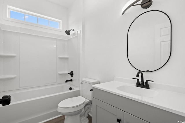 bathroom with toilet, vanity, washtub / shower combination, and wood finished floors
