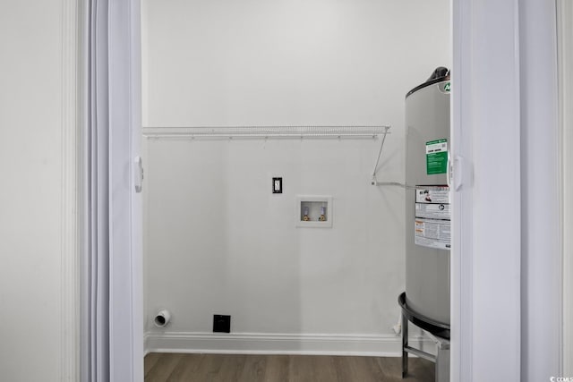 laundry room with electric water heater, wood finished floors, baseboards, and washer hookup