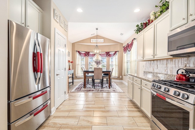 1367 Bermuda Grass Dr, Myrtle Beach, SC 29579 - kitchen featuring appliances with stainless steel finishes, a chandelier, lofted ceiling, backsplash, and hanging light fixtures