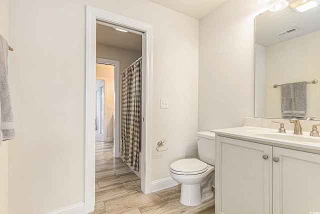 1367 Bermuda Grass Dr, Myrtle Beach, SC 29579 - bathroom with toilet, vanity, wood finished floors, baseboards, and a shower with shower curtain