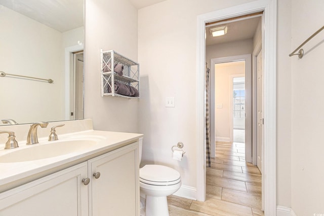1367 Bermuda Grass Dr, Myrtle Beach, SC 29579 - bathroom with vanity, toilet, wood finished floors, and baseboards