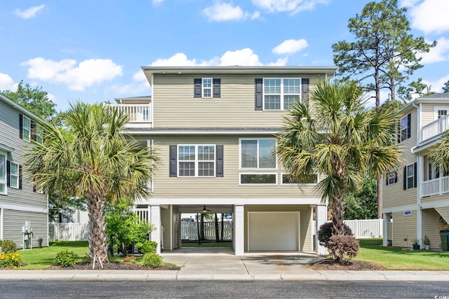 beach home featuring a carport, concrete driveway, and a garage