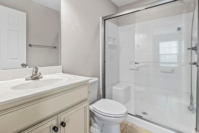 bathroom with a stall shower, toilet, vanity, and tile patterned flooring