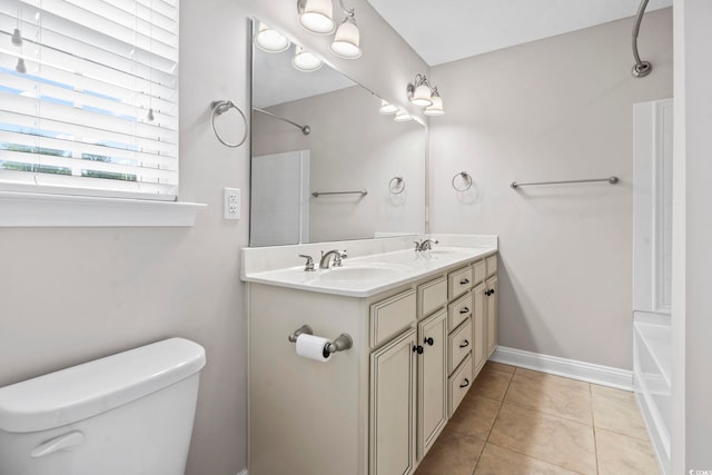 bathroom with toilet, double vanity, tile patterned floors, bathtub / shower combination, and baseboards