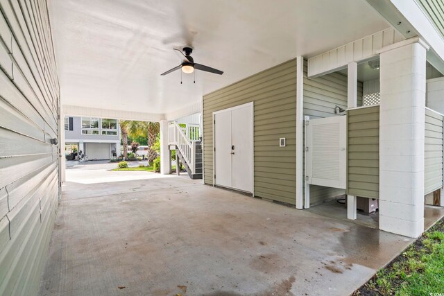 view of patio with stairs, a ceiling fan, and a carport