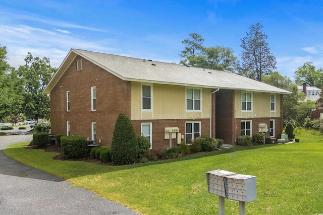 1015 Elm St Unit 4, Conway, SC 29526 - view of home's exterior with mail area, brick siding, a yard, and central AC
