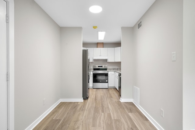 1015 Elm St Unit 4, Conway, SC 29526 - kitchen with stainless steel appliances, light wood-style flooring, white cabinets, under cabinet range hood, and baseboards