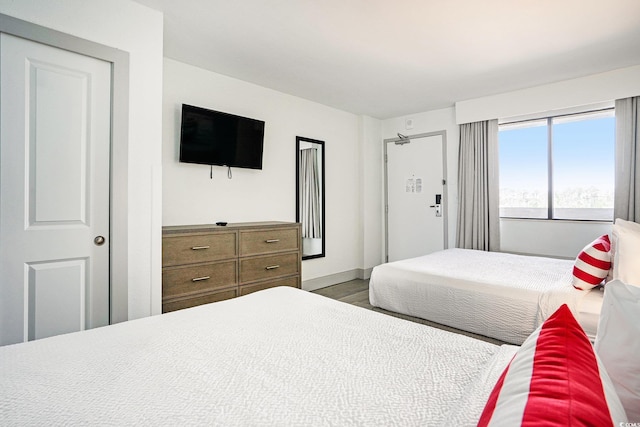 bedroom with wood finished floors and baseboards