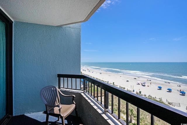 balcony with view of water and beach