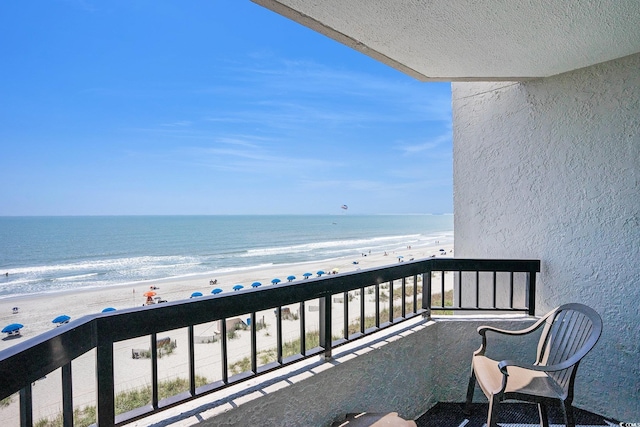 balcony featuring view of water and beach