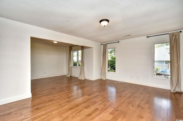 816 Kittiwake Ln, Murrells Inlet, SC 29576 - spare room featuring light wood finished floors, a textured ceiling, and baseboards