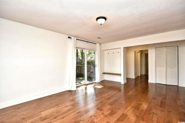 816 Kittiwake Ln, Murrells Inlet, SC 29576 - unfurnished bedroom featuring access to exterior, wood finished floors, a textured ceiling, and baseboards