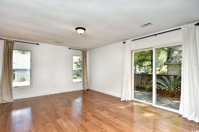816 Kittiwake Ln, Murrells Inlet, SC 29576 - unfurnished room featuring plenty of natural light, wood-type flooring, a textured ceiling, and baseboards