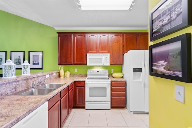 kitchen featuring white appliances, a sink, light tile patterned floors, light countertops, and reddish brown cabinets