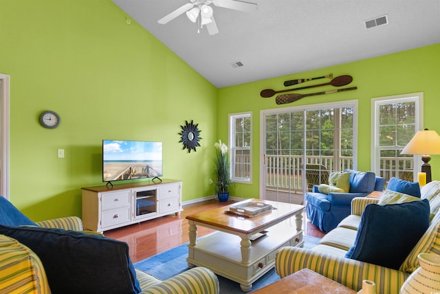 living room featuring a ceiling fan, wood finished floors, high vaulted ceiling, and baseboards