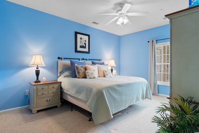 bedroom with light carpet, baseboards, and a ceiling fan