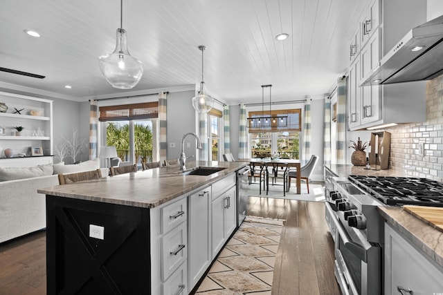 4832 Williams Island Dr, Little River, SC 29566 - kitchen with wall chimney exhaust hood, stainless steel appliances, a sink, wood-type flooring, and recessed lighting
