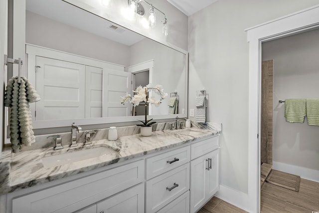 4832 Williams Island Dr, Little River, SC 29566 - full bathroom featuring double vanity, tiled shower, wood finished floors, and baseboards