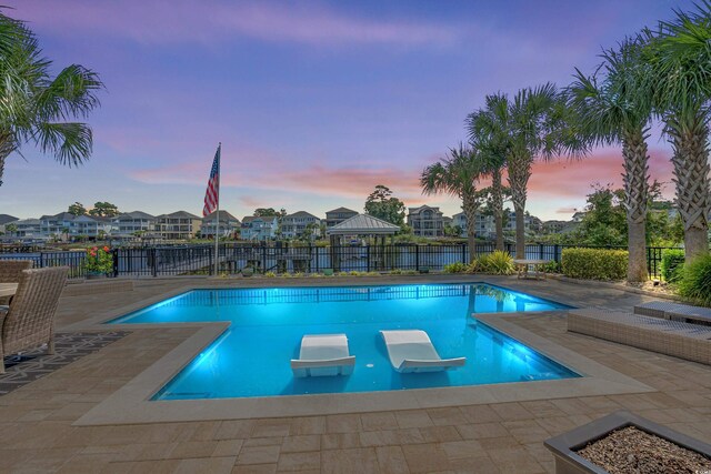 4832 Williams Island Dr, Little River, SC 29566 - pool at dusk with a fenced backyard, a patio area, and a residential view