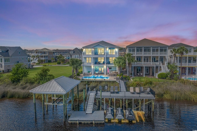 4832 Williams Island Dr, Little River, SC 29566 - dock with boat lift, an outdoor pool, a water view, a balcony, and a patio