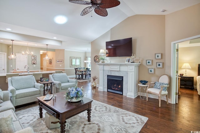 living area with a ceiling fan, baseboards, wood finished floors, high vaulted ceiling, and recessed lighting