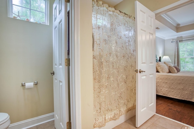 full bath featuring ensuite bathroom, ornamental molding, toilet, a shower with curtain, and tile patterned flooring