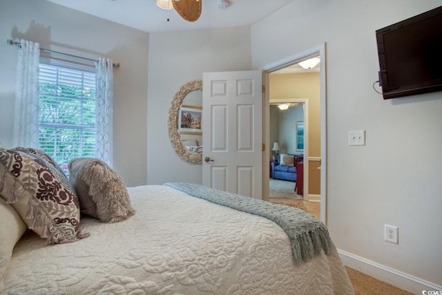 bedroom featuring carpet floors, baseboards, and a ceiling fan