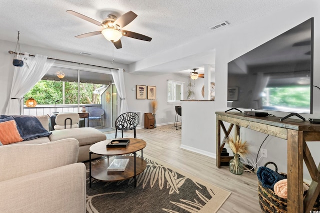 10301 N Kings Hwy Unit 10-4, Myrtle Beach, SC 29572 - living area featuring ceiling fan, a textured ceiling, wood finished floors, and baseboards