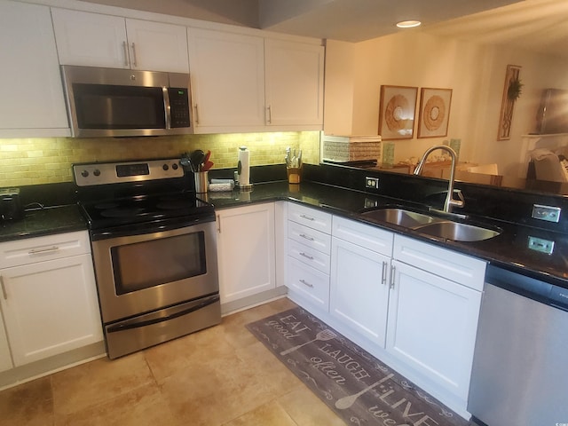 306 Westbury Ct Unit 2-B, Myrtle Beach, SC 29572 - kitchen with appliances with stainless steel finishes, a sink, white cabinetry, and decorative backsplash
