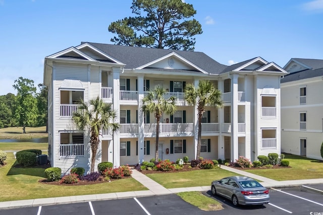 view of property featuring uncovered parking and a water view