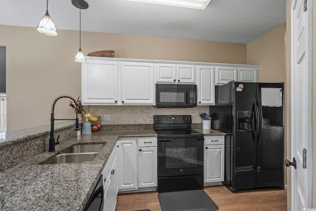 kitchen with black appliances, a sink, white cabinetry, and wood finished floors