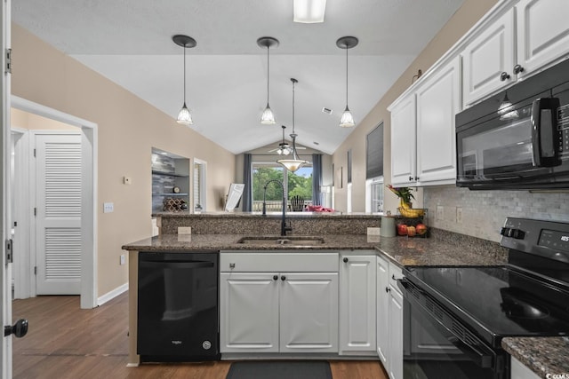 kitchen featuring black appliances, a sink, a peninsula, dark wood-type flooring, and backsplash
