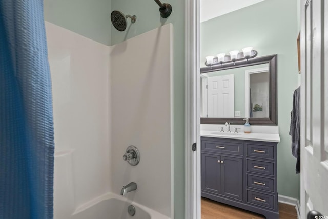 bathroom with shower / bath combo with shower curtain, vanity, and wood finished floors