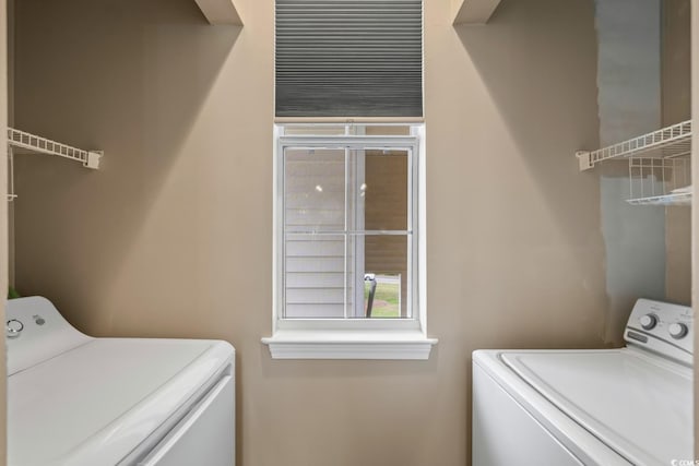 laundry room with washing machine and clothes dryer