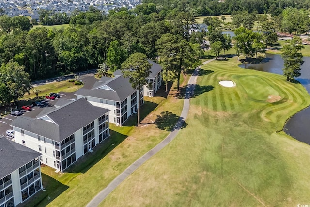 drone / aerial view of a nearby body of water and a local golf course