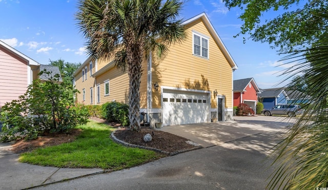 view of home's exterior featuring a garage and driveway