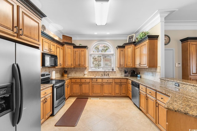 kitchen with appliances with stainless steel finishes, a sink, light stone countertops, tasteful backsplash, and crown molding