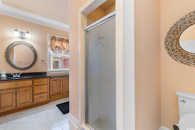 bathroom with a shower stall, vanity, toilet, and ornamental molding